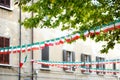 Row of small Italian flags hanging in the street in Desenzano del Garda town Royalty Free Stock Photo