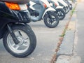 Row of small motobikes for sale or rent. selective focus on foreground with shallow depth of field Royalty Free Stock Photo