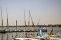 Row of small sailing yachts and boats for excursions on Nile River. Vacation, leisure and adventure travel. Luxor, Egypt Royalty Free Stock Photo