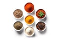 a row of small white bowls filled with various spices on a white surface Royalty Free Stock Photo