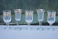 A row of small white glass crystal goblets Royalty Free Stock Photo