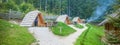 Row of small wooden cabins at Hija Glamping Lake Bloke in Nova Vas, Slovenia