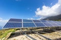 Row of solar collectors on mountain with blue sky Royalty Free Stock Photo