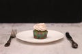 A row of spinach-mint cupcakes with fruit jam and berry cream on top