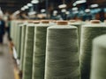 A row of spools of thread on a conveyor belt in a factory Royalty Free Stock Photo