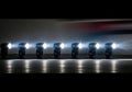 Row of Stage Spotlights with Bright White Beams and Dynamic Light Effects on Dark Background Royalty Free Stock Photo