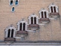 Row of staggered, rusty, outdoor balconies