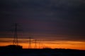 Steel power lines under a winter sunset Royalty Free Stock Photo