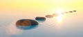 Row of stones in calm water in the wide ocean, meditation and zen concept image Royalty Free Stock Photo