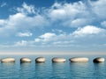 A row of stones in water Royalty Free Stock Photo