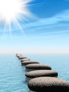 A row of stones in water with sun beam Royalty Free Stock Photo