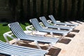 Row of stripy blue and white sunbeds Royalty Free Stock Photo
