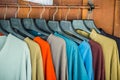 Row of summer sale clothes hanging on the rack. Fashion clothes on Sales at the flea market. Royalty Free Stock Photo