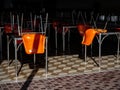 Row of table with upside down chairs in restaurant due to city lockdown during pandemic of Covid-19 virus to stop infection