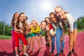 Row of teens standing on the volleyball game court