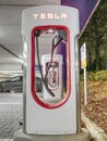 Row of Tesla SuperCharger EVSEs