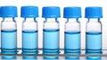 A row of test tubes with blue caps and blue liquid inside. Royalty Free Stock Photo