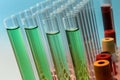 Row of test tubes in green tone