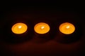 Row of three burning circle candles Royalty Free Stock Photo