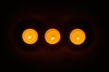 Row of three burning circle candles Royalty Free Stock Photo