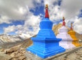 Row of three colorful stupas