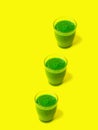 Row of three glasses of leafy greens smoothies spinach vegetables fruits on bright sunny yellow background. Healthy diet detox Royalty Free Stock Photo