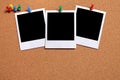 Row of three polaroid photo prints pinned to a cork board, copy space