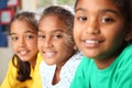 Row of three smiling young school girls