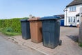 Row of three wheelie bins outside a house. UK