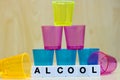 A row of tiles forming the word alcool.