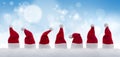Row of tiny Santa Claus hats in the snow Royalty Free Stock Photo