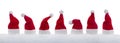 Row of tiny Santa Claus hats in the snow Royalty Free Stock Photo