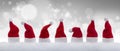 Row of tiny Santa Claus hats in the snow Royalty Free Stock Photo