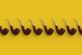 Row of tobacco pipes on yellow background