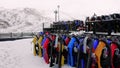 Row of toboggans at ski resort, poised for thrilling descents. Toboggan fun awaits on snowy slopes. Winter sport