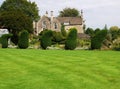 A row of topairy trees in a beautifuly landscaped garden