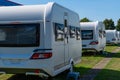 A row of touring caravans on standing on a sunny day in summer