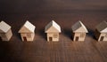 Row of toy houses. Find most suitable housing options. Offers on real estate market. Buying and selling. Mortgage. Valuation of