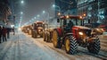 Row of Tractors Driving Down Snow-Covered Street Royalty Free Stock Photo