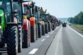 A Row of Tractors Lined Up on the Side of the Road