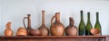 A row of the traditional Georgian wine jugs, clay cups and bottles on a shelf Royalty Free Stock Photo