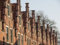 Row of traditional red brick buildings in the city Haarlem with canals in the Netherlands