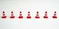 Row of traffic cones on a white background.