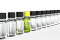 Row of transparent dropper bottles with one green exeption Royalty Free Stock Photo