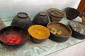 A row of trays holding various natural dyes used in the manufacturing of traditional lacquer ware in Myanmar Royalty Free Stock Photo