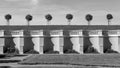 A row of trees above the balustrade in an old park black and white Royalty Free Stock Photo