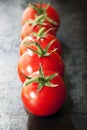 Row of Truss Tomatoes on Slate Royalty Free Stock Photo