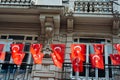 Row of Turkish flags hanging on a string from a building Royalty Free Stock Photo