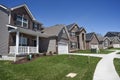 Row of two-story new residential homes for sale side by side in new subdivision grass yards and garages