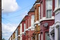 A row of typical British terraced houses in London with overhead cable lines Royalty Free Stock Photo